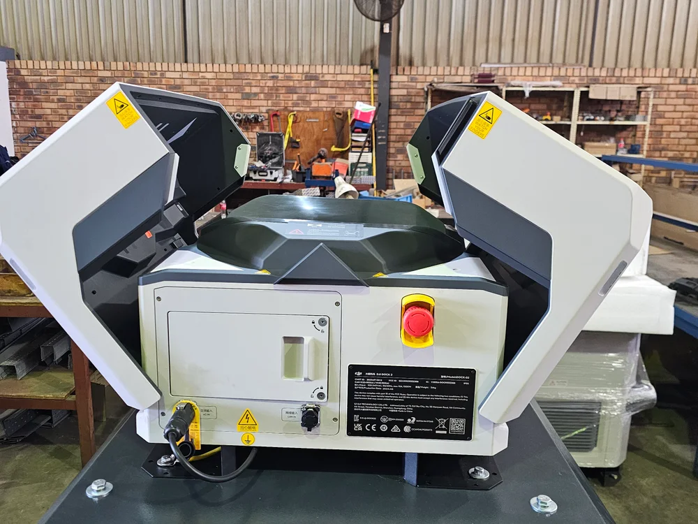 Drone docking station with its covers open on a steel support platform